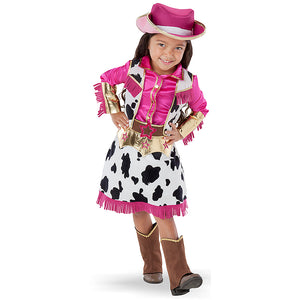 Little girl wearing a fringed cowgirl dress-up children's costume with pink top and black and white cow pattern vest and skirt with brown boot covers and pink hat.